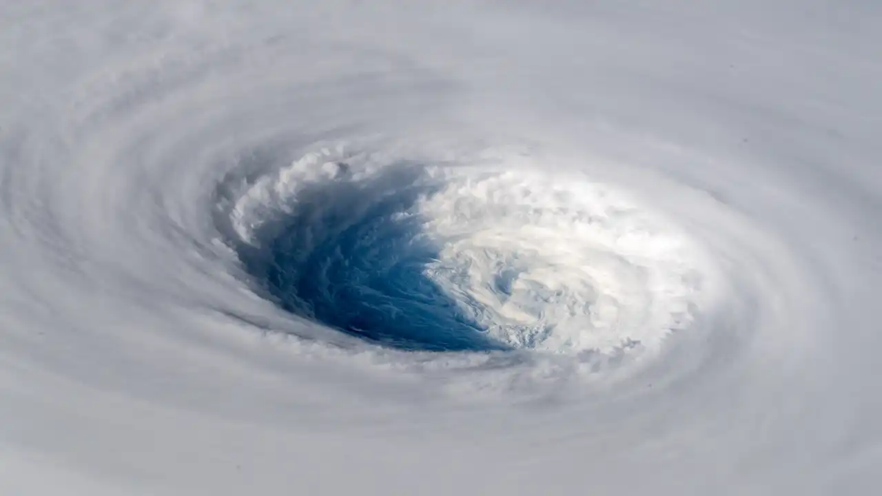 Satellite image showing the clear eye and swirling eyewall of a tropical cyclone 
