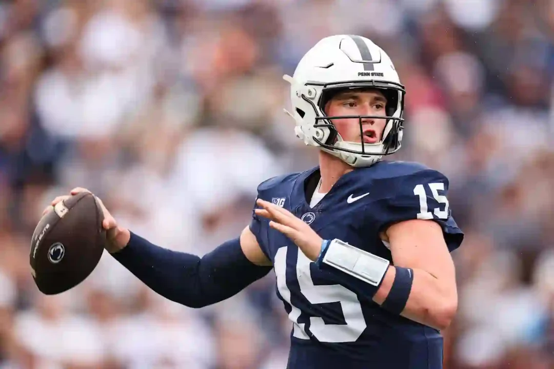 Penn State quarterback in action wearing number 15 jersey during a football game 
